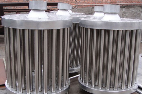 Industrial stainless steel condenser unit showing tube bundles and shell construction